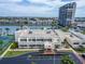 An aerial shot displays the property's proximity to the water, tennis court, and other buildings nearby at 7700 Sun Island S Dr # 107, South Pasadena, FL 33707
