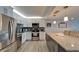 Bright kitchen boasts stainless appliances, granite countertops and white cabinetry at 7700 Sun Island S Dr # 107, South Pasadena, FL 33707