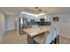Bright kitchen with white cabinetry, stainless appliances and granite countertop island at 7700 Sun Island S Dr # 107, South Pasadena, FL 33707
