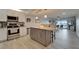 Open floorplan of the kitchen featuring stainless steel appliances, island and a view of the water at 7700 Sun Island S Dr # 107, South Pasadena, FL 33707