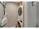 Convenient stacked laundry unit with storage; broom and mop storage alongside at 7700 Sun Island S Dr # 107, South Pasadena, FL 33707