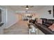Comfortable living room features wood-look flooring and flows into the kitchen area with bar stool seating at 7700 Sun Island S Dr # 107, South Pasadena, FL 33707