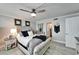 Spacious main bedroom with decoratively appointed wall, wood-look floors, and en-suite access at 7700 Sun Island S Dr # 107, South Pasadena, FL 33707