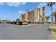 Outdoor parking lot with parked vehicles and a view of the building complex at 7700 Sun Island S Dr # 107, South Pasadena, FL 33707