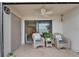 Outdoor patio featuring two chairs with a ceiling fan and sliding glass door with scenic views at 7700 Sun Island S Dr # 107, South Pasadena, FL 33707