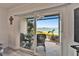 Sliding glass doors showcase a waterfront patio with comfortable seating and beautiful landscaping at 7700 Sun Island S Dr # 107, South Pasadena, FL 33707