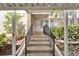 Outdoor steps with railings, walkway and manicured foliage at 7700 Sun Island S Dr # 107, South Pasadena, FL 33707
