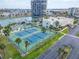 Aerial view of the tennis courts, with surrounding green space and nearby boat docking facilities at 7700 Sun Island S Dr # 107, South Pasadena, FL 33707