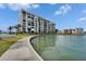 Water view with grass and condominium complex in the background at 7700 Sun Island S Dr # 107, South Pasadena, FL 33707