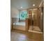 Modern bathroom featuring a soaking tub and separate glass-enclosed shower at 8273 Artisan Way, Seminole, FL 33777