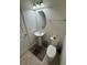 Clean half-bathroom with pedestal sink, toilet, and modern fixtures at 8273 Artisan Way, Seminole, FL 33777