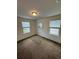 Bedroom with carpet, two windows, ceiling light, and neutral color scheme at 8273 Artisan Way, Seminole, FL 33777