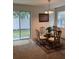 Cozy dining area with a glass table, decorative chandelier, and sliding glass doors at 8273 Artisan Way, Seminole, FL 33777
