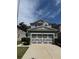 Two-story home with a gray exterior, well-maintained lawn, and a large two-car garage at 8273 Artisan Way, Seminole, FL 33777