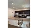 Modern kitchen with stainless steel appliances, granite counters, and dark wood cabinets at 8273 Artisan Way, Seminole, FL 33777