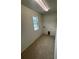 Laundry room with tile flooring, utility hookups, and natural light from the window at 8273 Artisan Way, Seminole, FL 33777