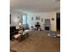 Spacious living room with carpeted floors, a fireplace, and comfortable seating at 8273 Artisan Way, Seminole, FL 33777