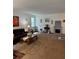 Spacious living room with carpeted floors, a fireplace, and comfortable seating at 8273 Artisan Way, Seminole, FL 33777