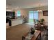 Open-concept living space with a dining area, kitchen island, and access to the backyard at 8273 Artisan Way, Seminole, FL 33777