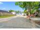 This view features a long driveway leading to the house with a roomy parking and storage area at 8615 Jackson Springs Rd, Tampa, FL 33615