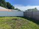 Fenced backyard featuring a combination of white vinyl and wood fencing at 8804 Briar Hollow Ct, Tampa, FL 33634