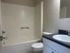 Bathroom with a white tub-shower combo, white toilet and sink with vanity at 8804 Briar Hollow Ct, Tampa, FL 33634