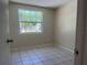 Bedroom featuring tile floors, a large window and neutral wall paint at 8804 Briar Hollow Ct, Tampa, FL 33634