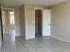 Bright bedroom featuring tile floors, a closet, neutral paint, and abundant natural light at 8804 Briar Hollow Ct, Tampa, FL 33634