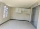 Enclosed porch featuring white cabinets, window, and sliding glass doors to the outside at 8804 Briar Hollow Ct, Tampa, FL 33634