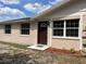 Charming single-story home featuring a brown front door, a tile entryway, and well-maintained landscaping at 8804 Briar Hollow Ct, Tampa, FL 33634