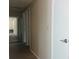 Well-lit hallway featuring modern floors, neutral walls, and access to multiple rooms at 8804 Briar Hollow Ct, Tampa, FL 33634