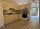 Kitchen featuring wood cabinets, granite countertops, and stainless steel appliances at 8804 Briar Hollow Ct, Tampa, FL 33634