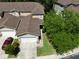 Aerial view of a two story tan townhome with a garage and landscaped yard at 8901 Casablanca Way, Tampa, FL 33626