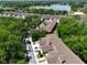 Aerial view of a lake community with townhomes, green landscaping, and mature trees at 8901 Casablanca Way, Tampa, FL 33626