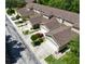 Aerial view of several two story tan townhomes with garages and landscaped yards at 8901 Casablanca Way, Tampa, FL 33626