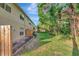 Scenic backyard with green lawn, wooden fence, and exterior deck at 8901 Casablanca Way, Tampa, FL 33626