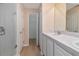 Bathroom featuring a walk-in shower, double vanity, and an open doorway to a walk-in closet at 8901 Casablanca Way, Tampa, FL 33626