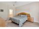 Clean bedroom featuring a queen bed, wood nightstand, and an en suite bathroom at 8901 Casablanca Way, Tampa, FL 33626