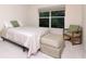Cozy bedroom includes a comfortable bed, ottoman, chair, and window views at 8901 Casablanca Way, Tampa, FL 33626