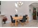 Well-lit dining room with hardwood floors, chandelier, and ample space for entertaining guests at 8901 Casablanca Way, Tampa, FL 33626