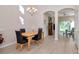 Formal dining room featuring hardwood floors, modern lighting, and access to the living room at 8901 Casablanca Way, Tampa, FL 33626