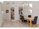 Dining room featuring hardwood floors, modern lighting fixtures, and a view to the kitchen area at 8901 Casablanca Way, Tampa, FL 33626