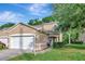 Charming two-story townhouse featuring a two-car garage, manicured lawn, and lush, mature landscaping at 8901 Casablanca Way, Tampa, FL 33626