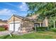 Two-story townhouse featuring a two-car garage and lush landscaping in the front yard at 8901 Casablanca Way, Tampa, FL 33626