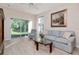 Cozy living room with hardwood floors, comfortable seating, and a sliding glass door with backyard views at 8901 Casablanca Way, Tampa, FL 33626