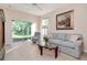 Comfortable living room with hardwood floors, plush seating, and natural light through sliding glass doors at 8901 Casablanca Way, Tampa, FL 33626