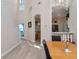 Bright living room with hardwood floors, staircase access, and view into the kitchen and breakfast nook at 8901 Casablanca Way, Tampa, FL 33626