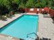 Community pool with tables, lounge chairs and a brick paver pool deck in a fenced area at 8901 Casablanca Way, Tampa, FL 33626