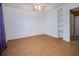 Bright bedroom features a ceiling fan, modern flooring, and built-in shelving at 9130 Dresden Ln, Port Richey, FL 34668