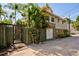 View of the backyard and fence, with lush tropical foliage and a garage at 921 24Th N Ave, St Petersburg, FL 33704
